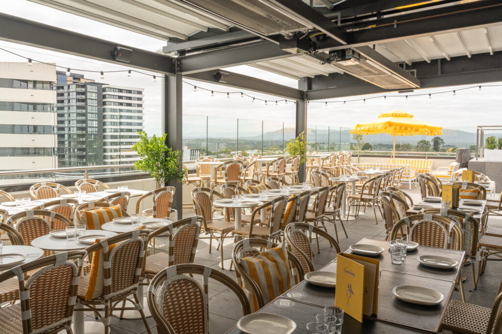Gambino Rooftop bar atmosphere at night with guests and city views